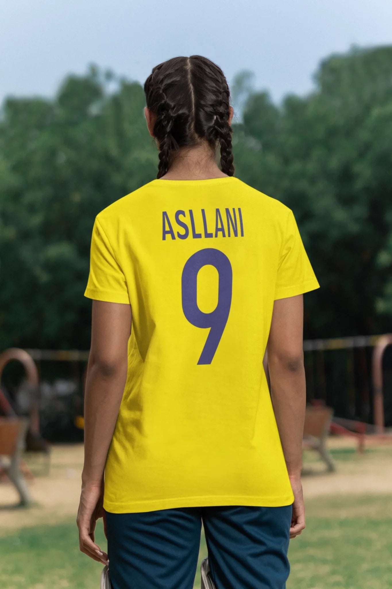 back-view-t-shirt-mockup-of-a-woman-standing-in-a-cricket-field-m39978