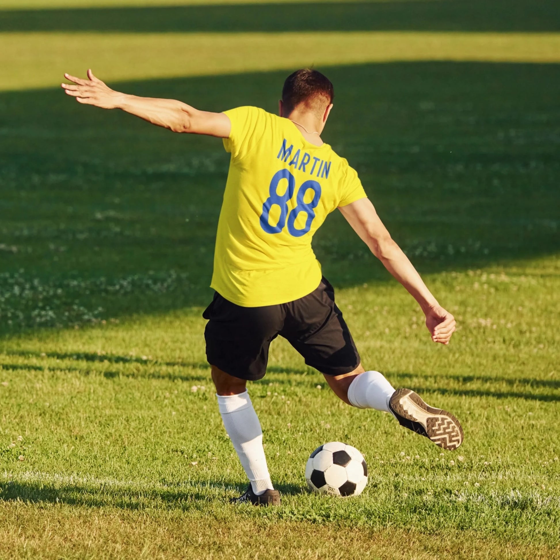back-view-t-shirt-mockup-of-a-soccer-player-kicking-a-ball-m16843-r-el2