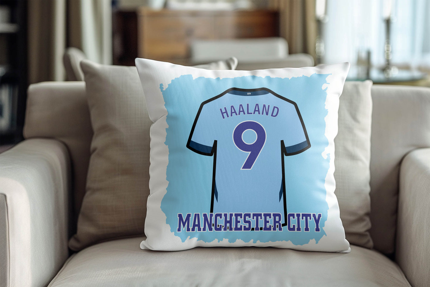 Pillow with Manchester City jersey design featuring 'Haaland 9' on a couch.